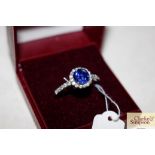 A 925 ring set central blue stone and chipped whit