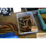 A box containing various old hammers and cold chis