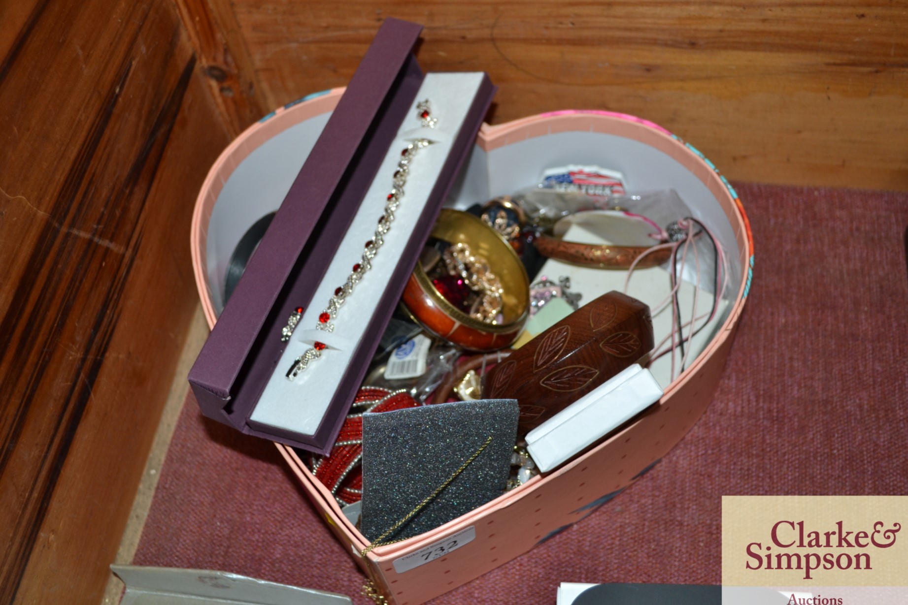 A heart shaped box of various costume jewellery
