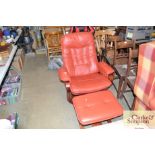 A red leather upholstered swivel chair with matchi