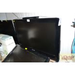 A Sharp flat screen television with remote control