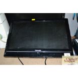 A Toshiba flat screen television lacking remote co