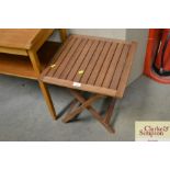 A small slatted teak folding table