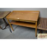 A small teak two tier serving table with two drawe