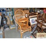 A cane armchair and similar foot stool