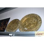 Two brass embossed plaques depicting tavern scenes