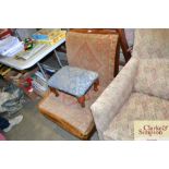 An upholstered nursing chair and foot stool