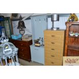 A modern grey painted hall cupboard with hangers a