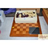 A chess board and a box of chess pieces