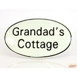 An oval replica enamel advertising sign for "Grand