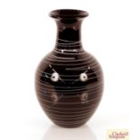 A black glass baluster vase with white line decora