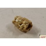 A carved bone Netsuke