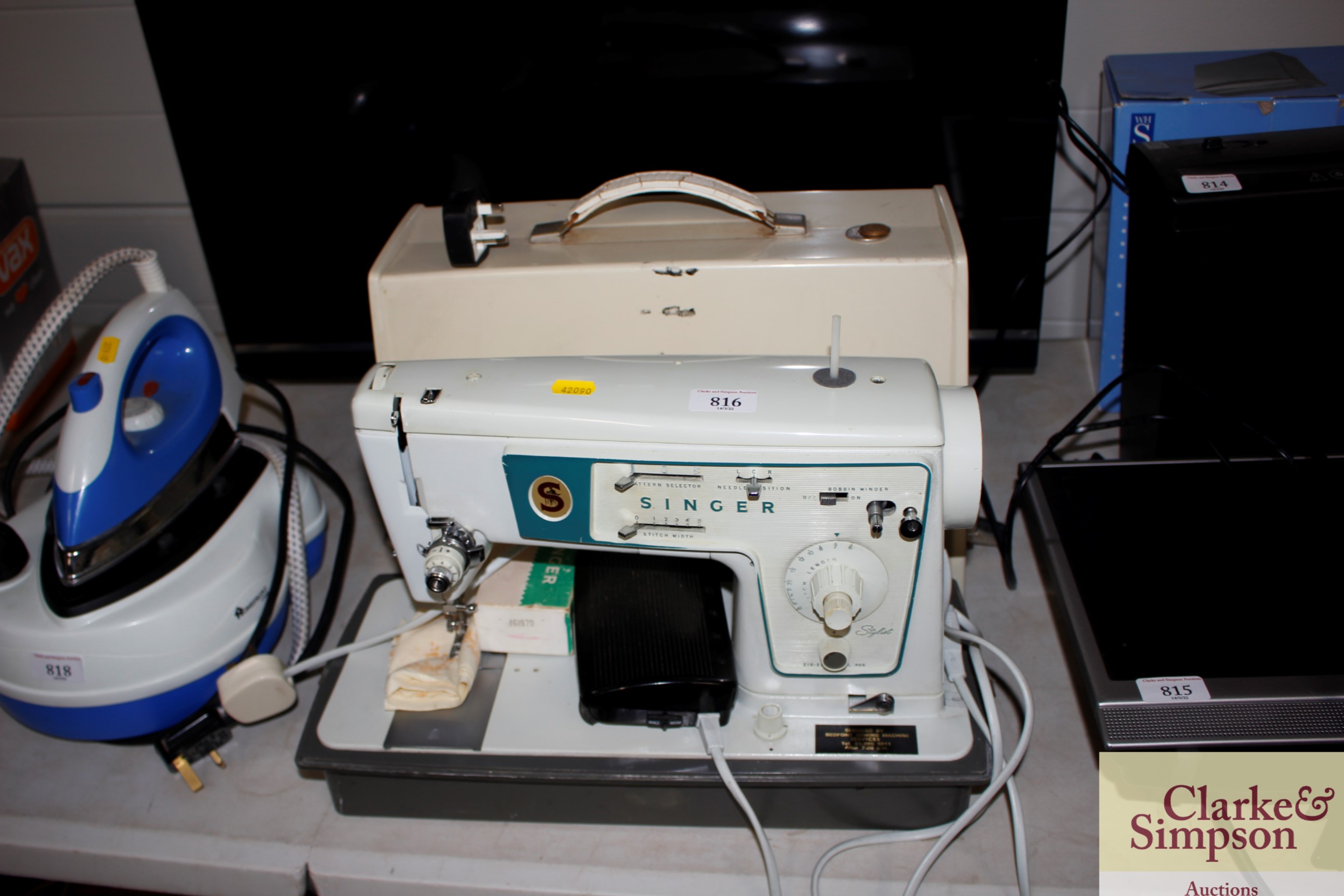 A Singer electric sewing machine in fitted case