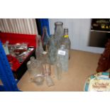 A quantity of odd glass bottles