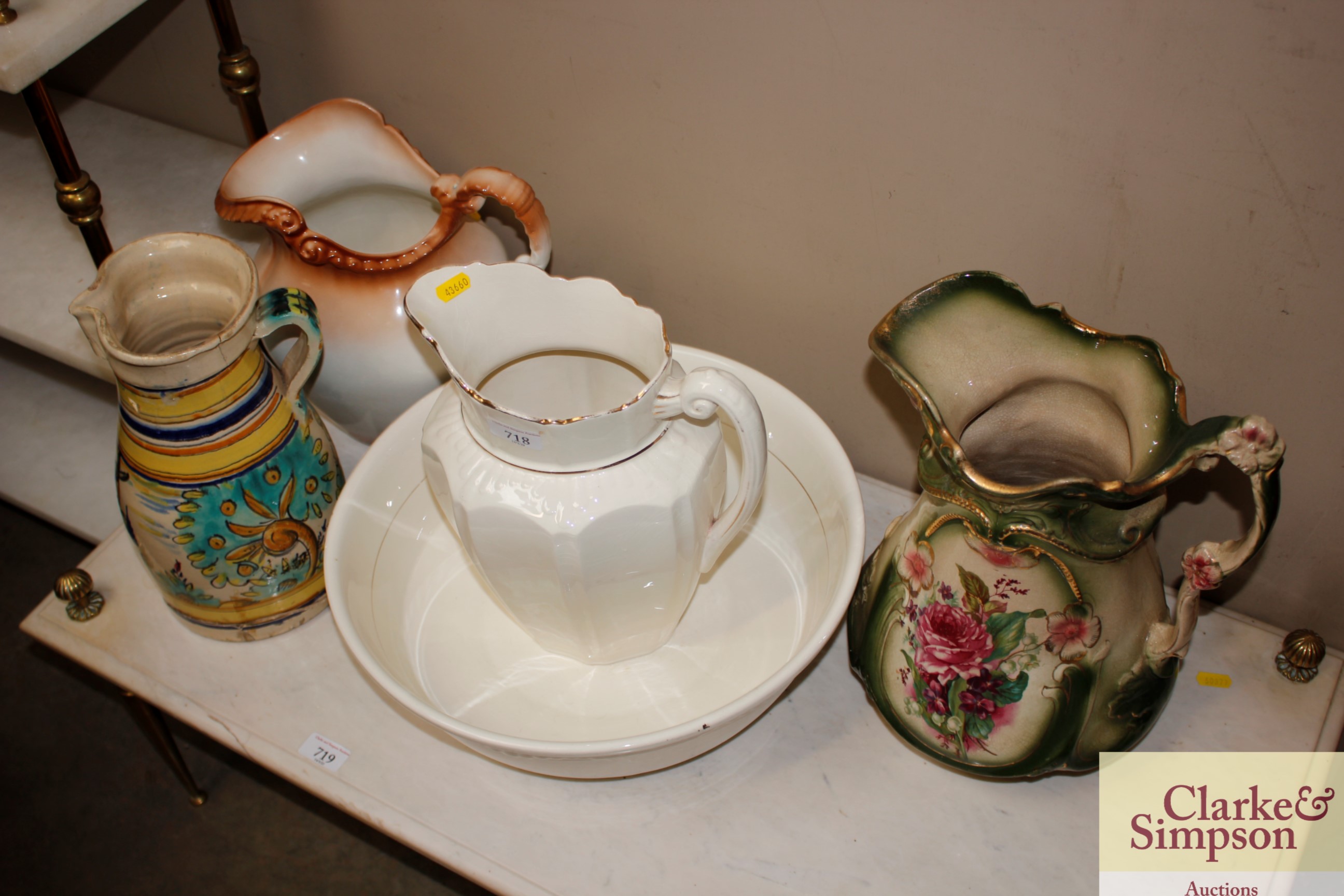 A gilt decorated wash jug and bowl, two other wash