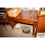 A Victorian mahogany writing desk raised on ring t