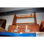 A wooden shoe rack together with suitcase