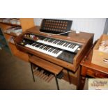 A Yamaha electric organ with stool