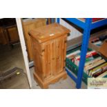 A stripped pine cupboard of small proportions