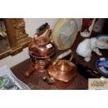 An antique copper kettle on spirit heater stand; a