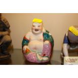 A Chinese porcelain figure of a Buddha, impress ma