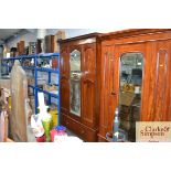 An Edwardian mirror fronted wardrobe fitted single