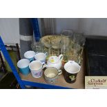 A quantity of mugs, glassware and place mats