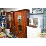 A Victorian mahogany mirror fronted wardrobe fitte