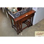 An oak nest of three occasional tables