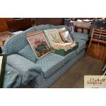 A green upholstered three settee