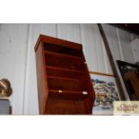 A set of mahogany hanging wall shelves