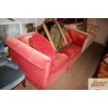 A pink upholstered modern settee