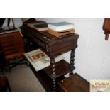 A Victorian carved oak three tier buffet fitted tw