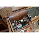 A Singer hand sewing machine in fitted case