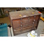 A small mahogany seven drawer workshop storage uni