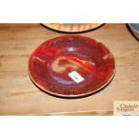 A Sang de Boeuf Studio pottery dish impress symbols to the rim