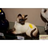 A Beswick figure of a reclining Siamese cat design