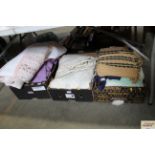 Three boxes of various blankets, curtains and beds