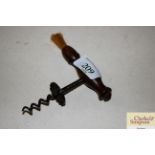 A Victorian corkscrew with turned wooden handle an