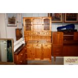 A modern pine kitchen dresser with glazed upper se