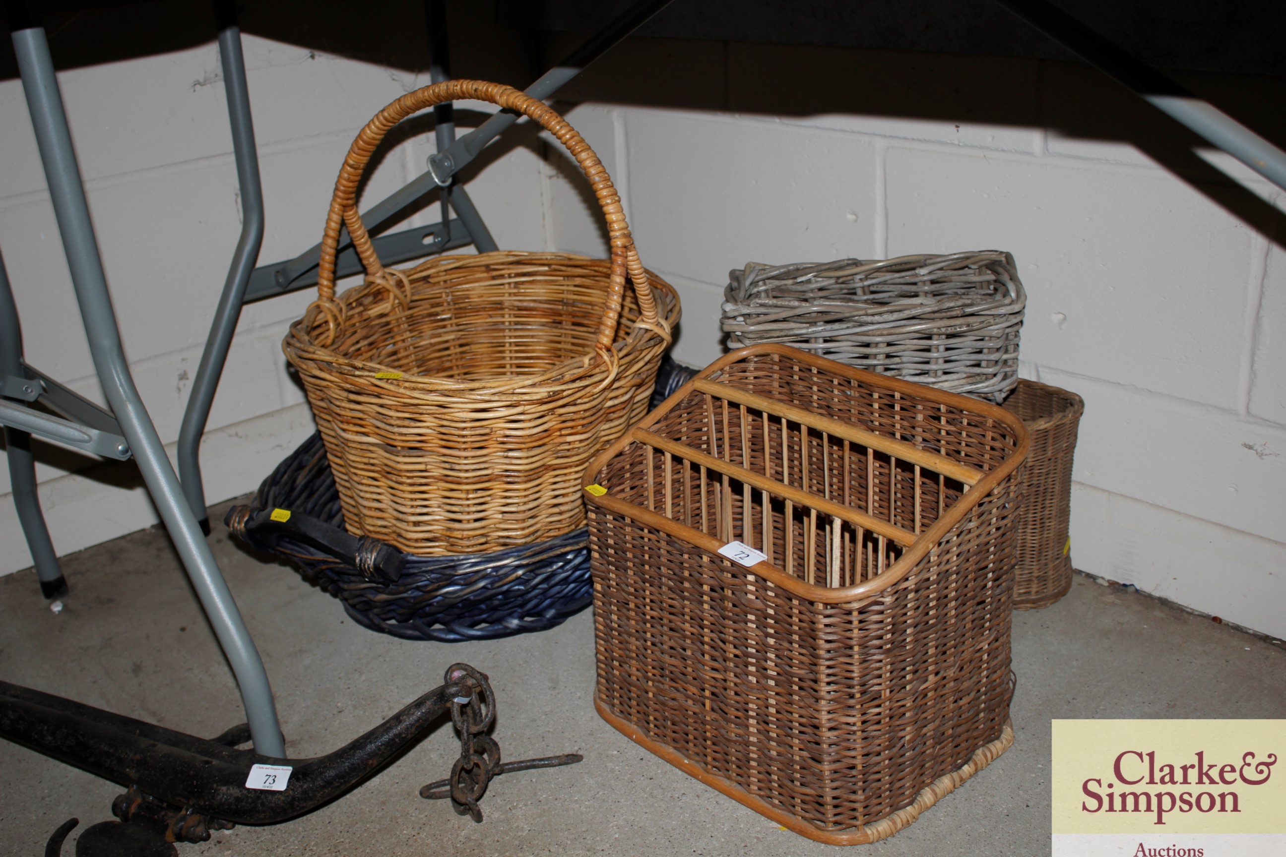 A wicker magazine rack and four baskets