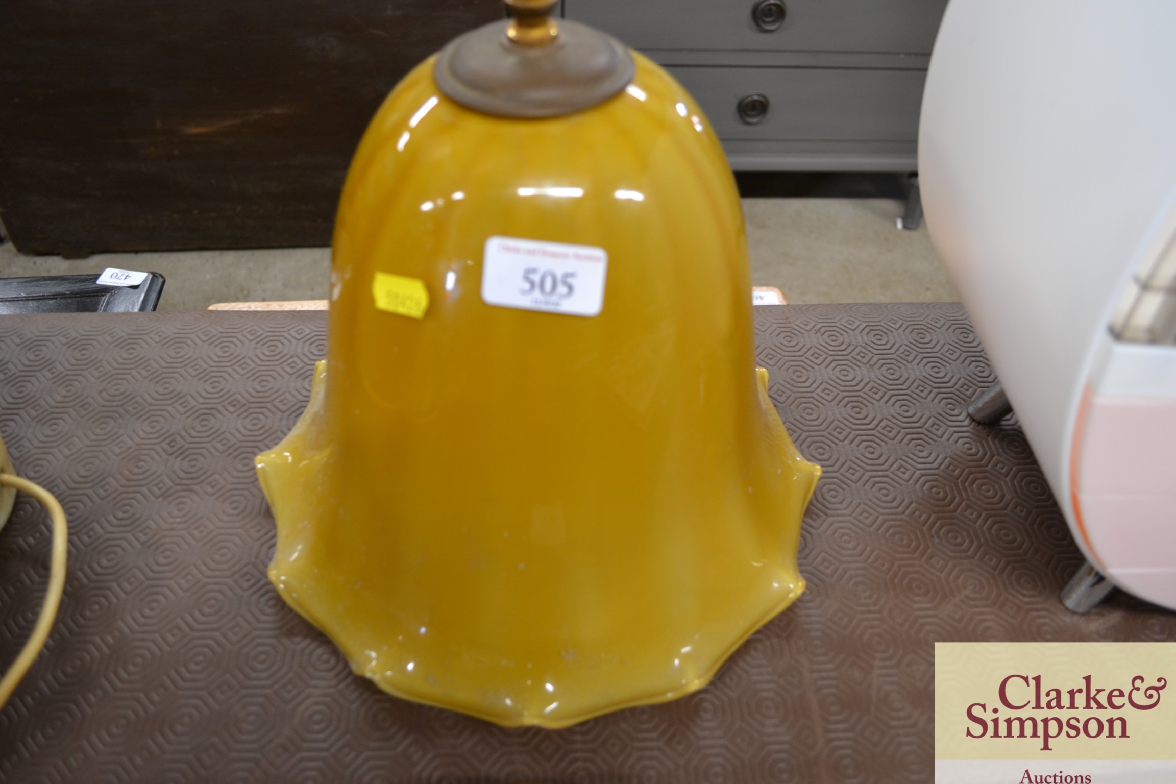 A large amber glass pendant light fitting