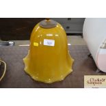 A large amber glass pendant light fitting