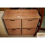 A wicker and metal ware four drawer storage chest