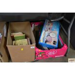 Two boxes of various books, games, twin handled tr