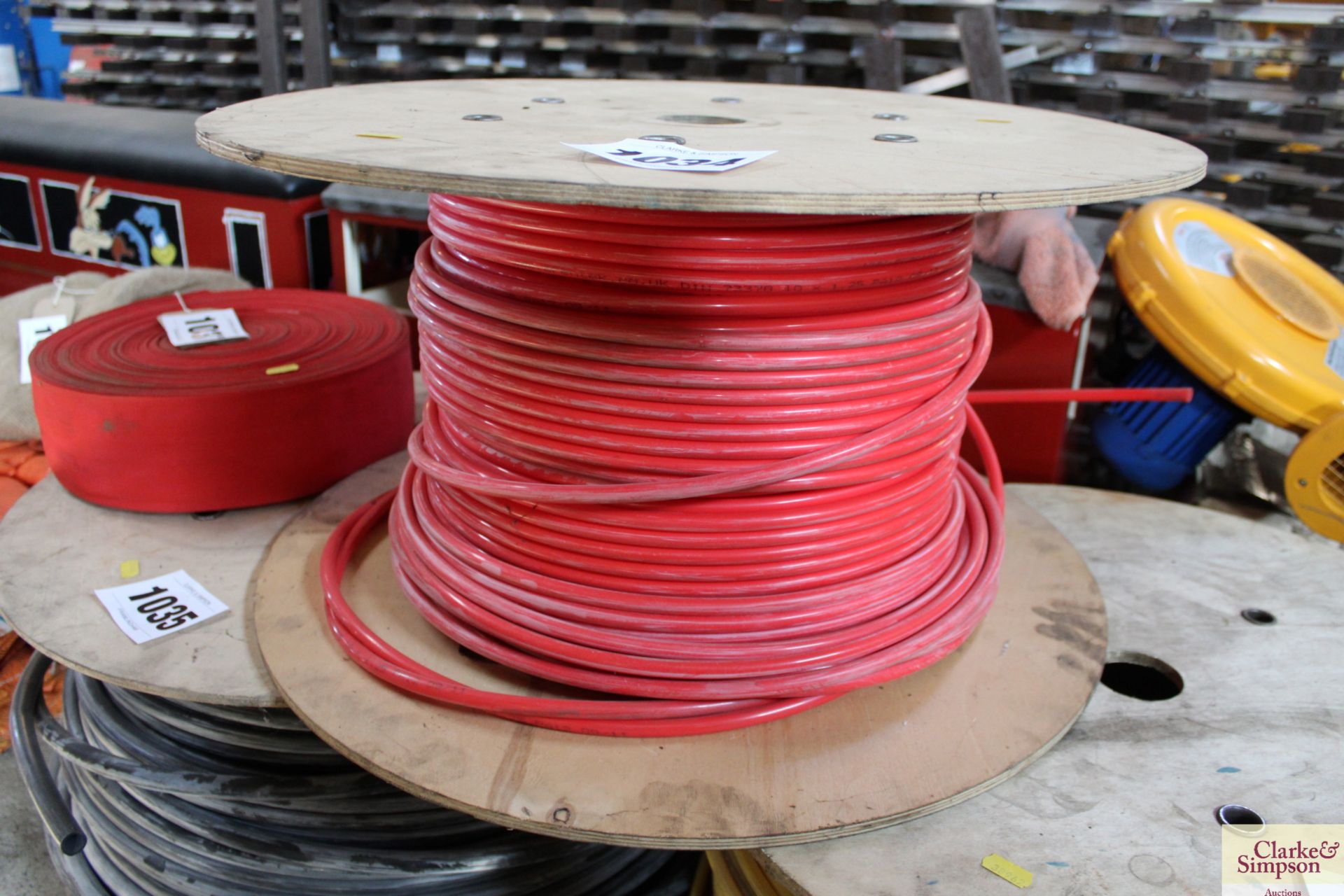 Drum of red trailer airline pipe. V