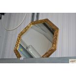 An octagonal gilt framed decorative wall mirror