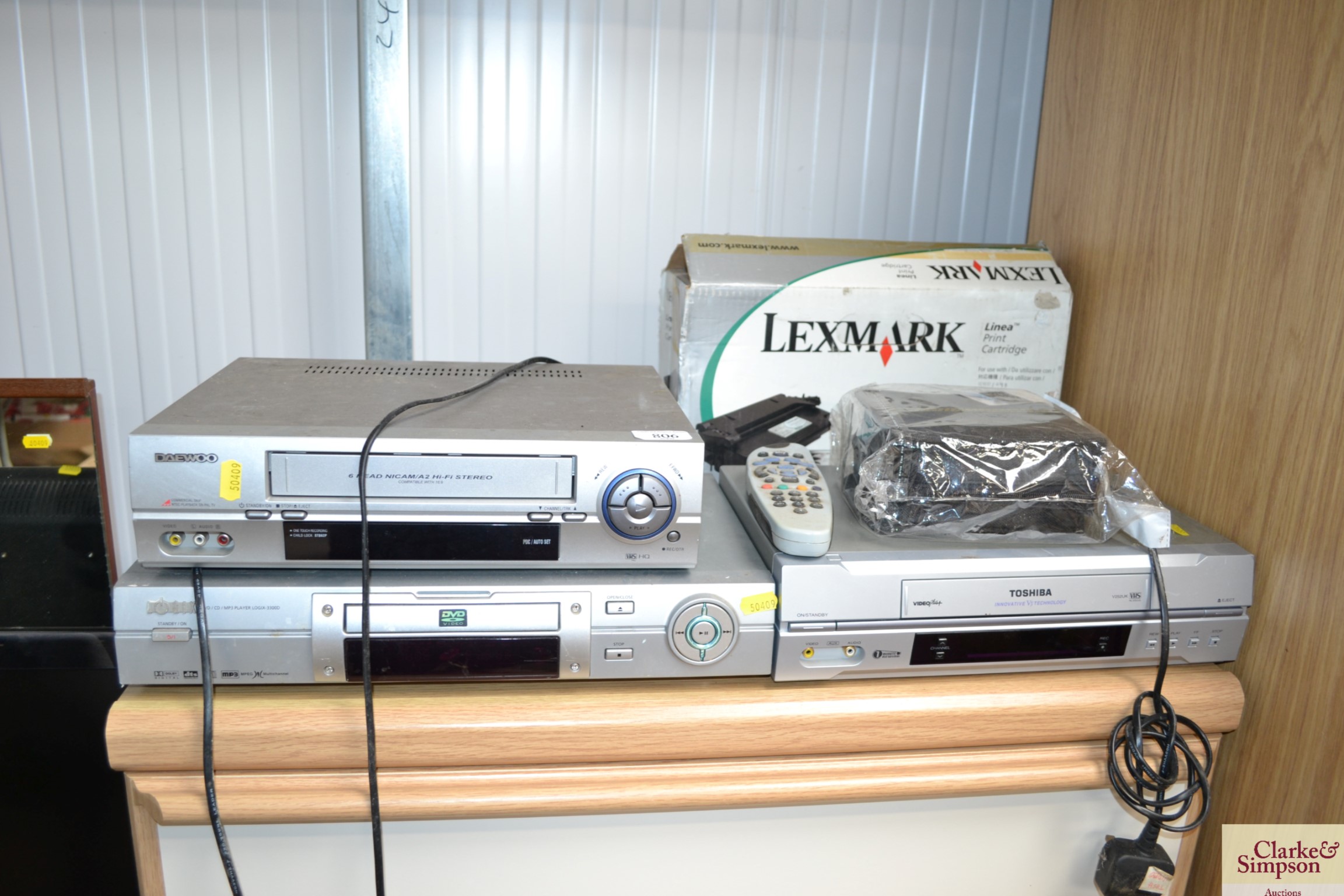 A Toshiba VHS player, a Logix DVD player, a Daewoo