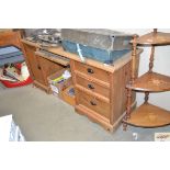 A stripped pine modern kneehole desk