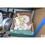 A box containing various tea and coffeeware to inc